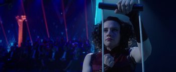 Movie still from “The Spy Who Dumped Me” (2018), directed by Susanna Fogel – A woman holding a microphone in front of an audience; Medium shot, Low angle