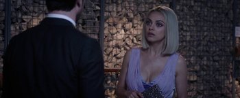 Movie still from “The Spy Who Dumped Me” (2018), directed by Susanna Fogel – A woman in a purple dress talking to a man in a black suit; Close Up shot, Over the shoulder angle