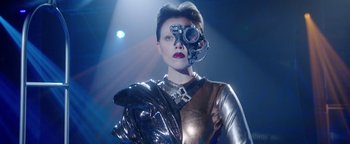 Movie still from “The Spy Who Dumped Me” (2018), directed by Susanna Fogel – A woman in a silver outfit with a camera on her face; Close Up shot, Low angle