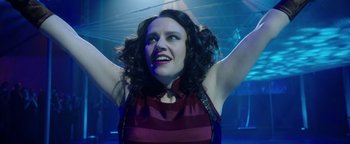 Movie still from “The Spy Who Dumped Me” (2018), directed by Susanna Fogel – A woman with her arms up in the air; Close Up shot, Low angle