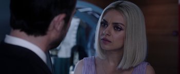 Movie still from “The Spy Who Dumped Me” (2018), directed by Susanna Fogel – A woman in a purple dress is talking to a man in a black suit; Close Up shot, Over the shoulder angle