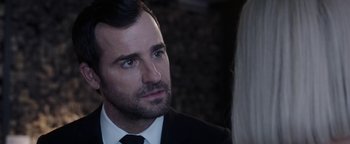 Movie still from “The Spy Who Dumped Me” (2018), directed by Susanna Fogel – A person wearing a suit and tie; Close Up shot, Over the shoulder angle