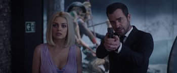Movie still from “The Spy Who Dumped Me” (2018), directed by Susanna Fogel – A man and a woman holding guns in a room; Close Up shot, Over the shoulder angle