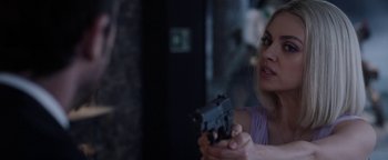 Movie still from “The Spy Who Dumped Me” (2018), directed by Susanna Fogel – A woman is holding a gun in her hand; Close Up shot, Over the shoulder angle