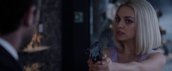 Movie still from “The Spy Who Dumped Me” (2018), directed by Susanna Fogel – A woman holding a gun in her hand; Close Up shot, Over the shoulder angle