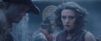 Movie still from “The Spy Who Dumped Me” (2018), directed by Susanna Fogel – A woman standing next to a man wearing a helmet; Close Up shot, Over the shoulder angle