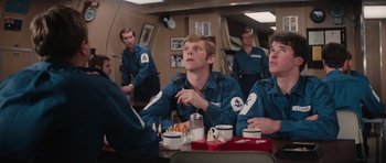 Movie still from “The Spy Who Loved Me” (1977), directed by Lewis Gilbert – A group of people sitting around a table; Medium shot, Over the shoulder angle