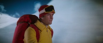 Movie still from “The Spy Who Loved Me” (1977), directed by Lewis Gilbert – A man wearing a yellow jacket and a red hat; Medium shot, Low angle