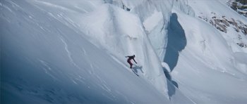 Movie still from “The Spy Who Loved Me” (1977), directed by Lewis Gilbert – A person is skiing down a steep mountain slope; Extreme Wide shot, Low angle
