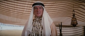 Movie still from “The Spy Who Loved Me” (1977), directed by Lewis Gilbert – A middle eastern man wearing a traditional outfit; Medium shot, Over the shoulder angle
