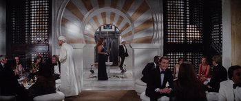 Movie still from “The Spy Who Loved Me” (1977), directed by Lewis Gilbert – A group of people standing in a room; Wide shot, Low angle