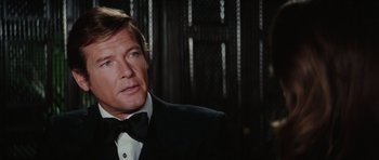 Movie still from “The Spy Who Loved Me” (1977), directed by Lewis Gilbert – A person wearing a suit and tie; Close Up shot, Over the shoulder angle