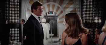 Movie still from “The Spy Who Loved Me” (1977), directed by Lewis Gilbert – A man and a woman in formal wear talking; Medium shot, Low angle