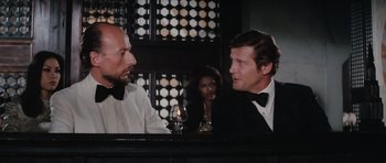 Movie still from “The Spy Who Loved Me” (1977), directed by Lewis Gilbert – A man in a tuxedo and a woman in a black dress; Medium shot, Over the shoulder angle