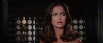 Movie still from “The Spy Who Loved Me” (1977), directed by Lewis Gilbert – A beautiful woman with long brown hair wearing a green necklace; Close Up shot, Low angle