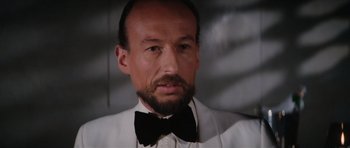 Movie still from “The Spy Who Loved Me” (1977), directed by Lewis Gilbert – A person wearing a suit and bow tie; Close Up shot, Low angle