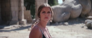 Movie still from “The Spy Who Loved Me” (1977), directed by Lewis Gilbert – A beautiful woman in a black dress posing for a picture; Close Up shot, Low angle