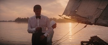 Movie still from “The Spy Who Loved Me” (1977), directed by Lewis Gilbert – A man and a woman standing next to each other on a sailboat; Medium shot, Over the shoulder angle