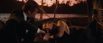 Movie still from “The Spy Who Loved Me” (1977), directed by Lewis Gilbert – A man and a woman laying on a couch; Medium shot, High angle