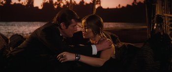 Movie still from “The Spy Who Loved Me” (1977), directed by Lewis Gilbert – A man and a woman are hugging in front of a sunset; Medium shot, High angle