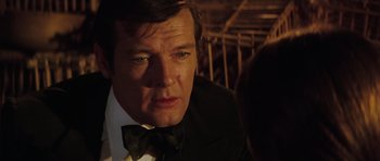 Movie still from “The Spy Who Loved Me” (1977), directed by Lewis Gilbert – A person wearing a suit and bow tie; Close Up shot, Over the shoulder angle