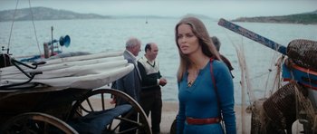 Movie still from “The Spy Who Loved Me” (1977), directed by Lewis Gilbert – A woman standing next to a body of water; Medium shot, Low angle
