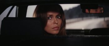Movie still from “The Spy Who Loved Me” (1977), directed by Lewis Gilbert – A woman looking out the window of a car; Close Up shot, Low angle