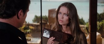 Movie still from “The Spy Who Loved Me” (1977), directed by Lewis Gilbert – A beautiful woman holding a wallet with a picture of a man in it; Close Up shot, Over the shoulder angle