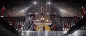 Movie still from “The Spy Who Loved Me” (1977), directed by Lewis Gilbert – A group of men standing on top of a metal staircase; Extreme Wide shot, Low angle