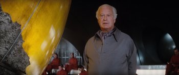 Movie still from “The Spy Who Loved Me” (1977), directed by Lewis Gilbert – An older man standing in front of a group of people; Medium shot, Low angle