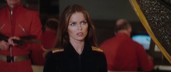 Movie still from “The Spy Who Loved Me” (1977), directed by Lewis Gilbert – A woman in a uniform looking at the camera; Close Up shot, Over the shoulder angle
