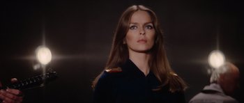 Movie still from “The Spy Who Loved Me” (1977), directed by Lewis Gilbert – A woman with long brown hair wearing a military uniform; Close Up shot, Low angle