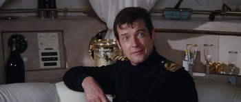 Movie still from “The Spy Who Loved Me” (1977), directed by Lewis Gilbert – A person sitting in a room; Close Up shot, High angle