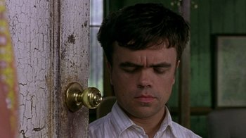 Movie still from “The Station Agent” (2003), directed by Tom McCarthy – A man standing in front of a wooden door; Close Up shot, High angle