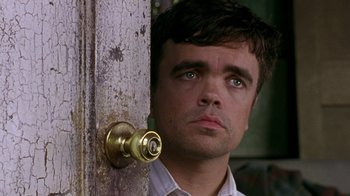 Movie still from “The Station Agent” (2003), directed by Tom McCarthy – A person standing next to a door; Close Up shot, Over the shoulder angle