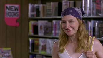 Movie still from “The Station Agent” (2003), directed by Tom McCarthy – A woman wearing a bandana in front of a book shelf; Close Up shot, Low angle