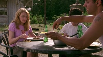 Movie still from “The Station Agent” (2003), directed by Tom McCarthy – A group of people sitting at a table eating food; Medium shot, High angle