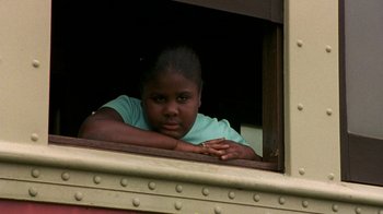 Movie still from “The Station Agent” (2003), directed by Tom McCarthy – A young girl leaning on the window of a train car; Close Up shot, Low angle