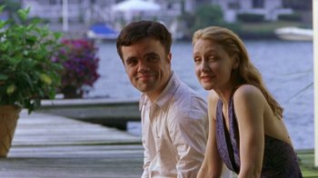 Movie still from “The Station Agent” (2003), directed by Tom McCarthy – A man and a woman posing for a picture; Medium shot, Over the shoulder angle