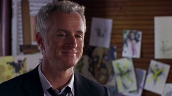 Movie still from “The Station Agent” (2003), directed by Tom McCarthy – A person wearing a suit and tie; Close Up shot, Low angle