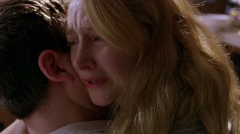 Movie still from “The Station Agent” (2003), directed by Tom McCarthy – A person with their head on a persons shoulder; Close Up shot, Over the shoulder angle