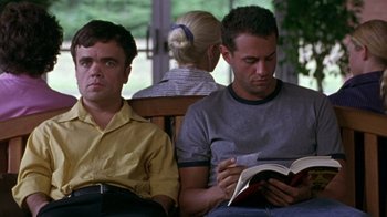 Movie still from “The Station Agent” (2003), directed by Tom McCarthy – Two men and a woman are sitting on a bench and reading; Medium shot, Over the shoulder angle