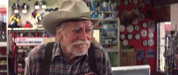 Movie still from “The Straight Story” (1999), directed by David Lynch – An old man with a cowboy hat and a beard; Close Up shot, Over the shoulder angle