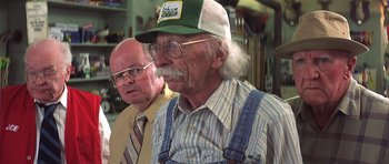 Movie still from “The Straight Story” (1999), directed by David Lynch – A man with a beard and a hat and a man with a beard and a tie; Medium shot, Low angle