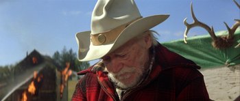 Movie still from “The Straight Story” (1999), directed by David Lynch – An older man wearing a cowboy hat and jacket; Close Up shot, Low angle