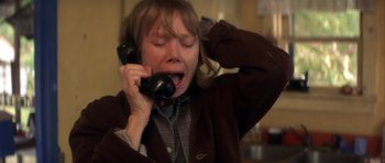 Movie still from “The Straight Story” (1999), directed by David Lynch – A woman crying while talking on a phone; Close Up shot, High angle