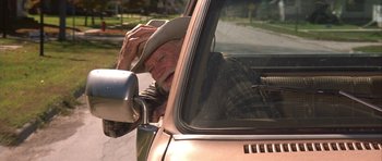 Movie still from “The Straight Story” (1999), directed by David Lynch – An older man in a cowboy hat looking out the window of a truck; Medium shot, Low angle