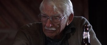 Movie still from “The Straight Story” (1999), directed by David Lynch – An older man with glasses and a beard; Close Up shot, High angle