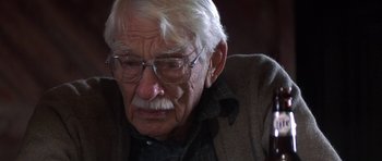 Movie still from “The Straight Story” (1999), directed by David Lynch – An old man with glasses is looking at the camera; Close Up shot, Over the shoulder angle