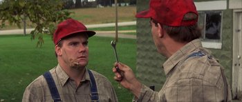 Movie still from “The Straight Story” (1999), directed by David Lynch – A man holding a wrench in front of another man's face; Close Up shot, Over the shoulder angle